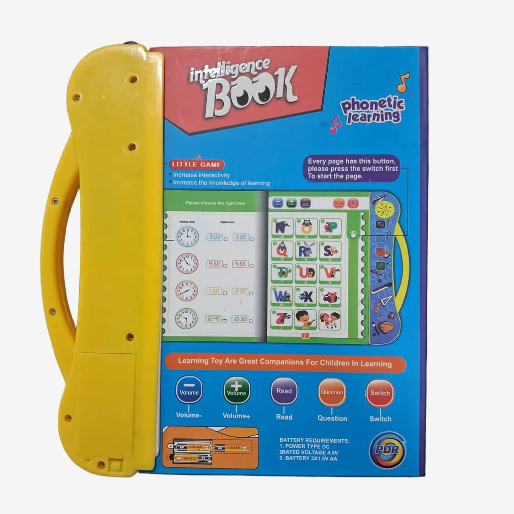 A children's toy learning book with a bright yellow handle and a blue front cover, photographed on a cluttered desk with school supplies visible around it.